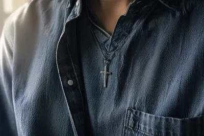 Silver Cross Necklace on Blue Denim Shirt