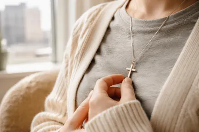 Cross Pendant on Gray Shirt in Morning Light