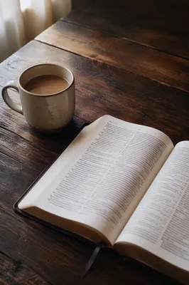 Open Book and Tea on Wooden Table