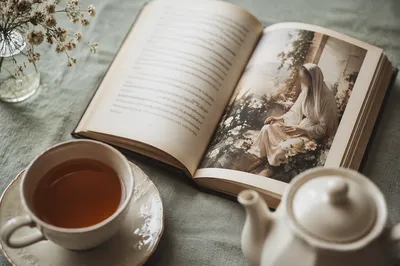 Open Book and Tea on Linen Table