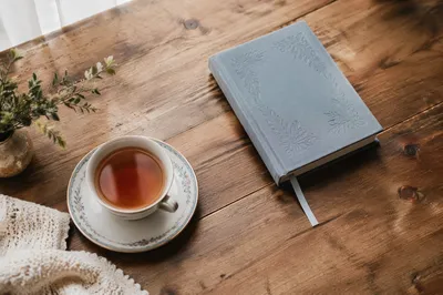 Devotional Book and Tea on Wooden Table