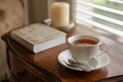 Tea Cup and Book on Wooden Table