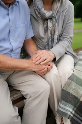 Elderly Couple Praying on Park Bench