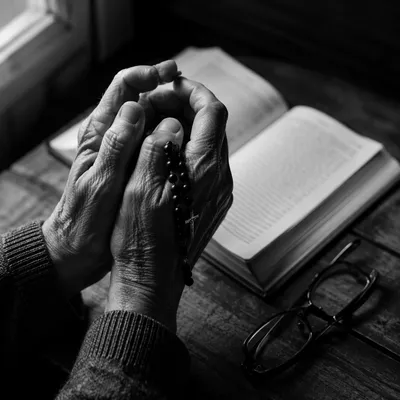 Elderly Hands Praying With Rosary Beads