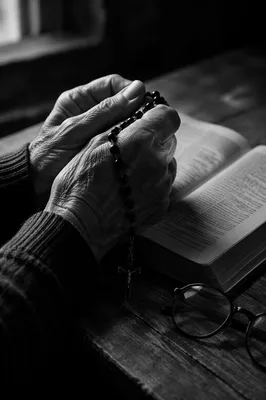 Elderly Hands Holding Rosary in Prayer