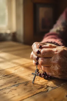 Elderly Hands Holding Rosary in Prayer
