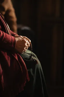 Elderly Hands Holding Rosary in Prayer