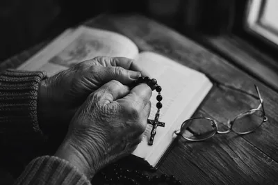 Elderly Hands Praying With Rosary Beads