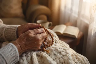 Elderly Hands Holding Wooden Prayer Beads