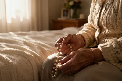 Elderly Hands Holding Rosary Beads at Dawn