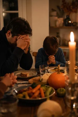 Family Gratitude at Candlelit Dinner Table