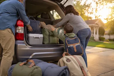 Family Loading Minivan for Sunrise Road Trip