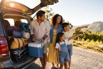 Family Road Trip Beside Packed Car