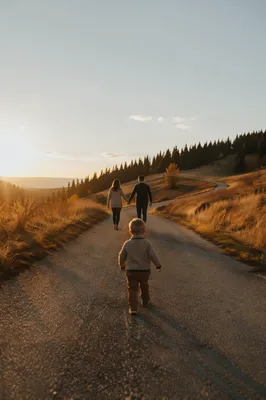 Family Walking Country Road at Sunset