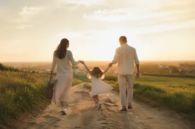 Family Walking Country Road at Sunset