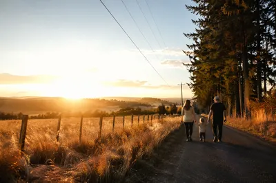 Family Walking Country Road at Sunset