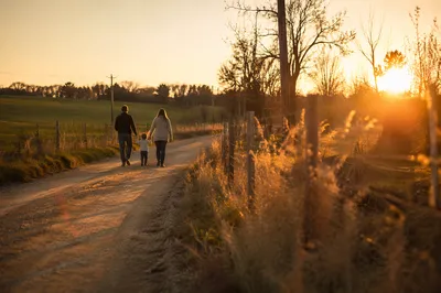 Family Walking Country Road at Sunset