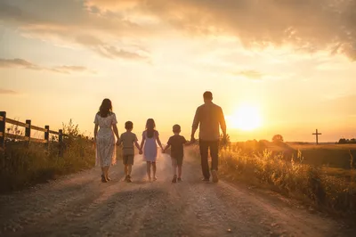 Family Walking Country Road at Sunset