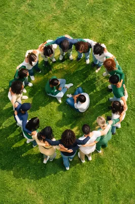 Overhead Friends Group Hug on Green Lawn