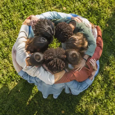 Overhead Friends Group Hug on Grass