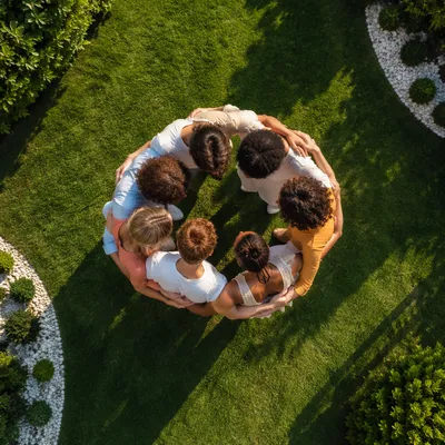 Friends Group Hug Circle on Green Lawn