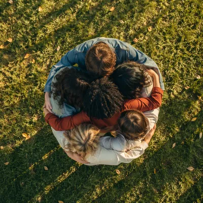 Friends Group Hug Circle on Grass