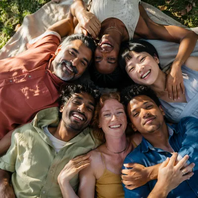 Six Friends Hugging on Picnic Blanket