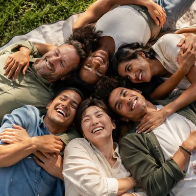 Six Friends Hugging on Picnic Blanket