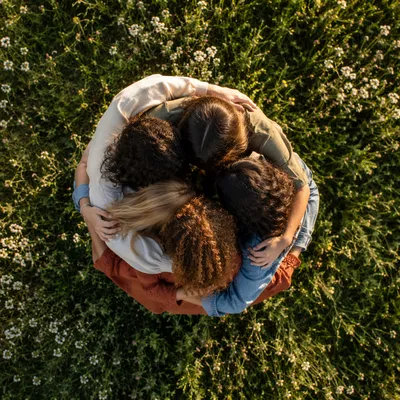 Overhead Friends Group Hug in Sunlit Meadow