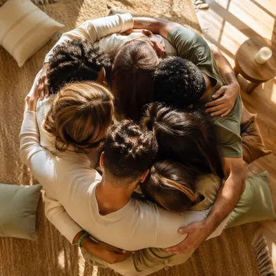 Overhead Friends Group Hug in Sunlit Living Room