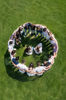 Friends Group Hug Circle on Green Lawn