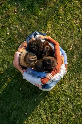 Overhead Friends Group Hug on Grass