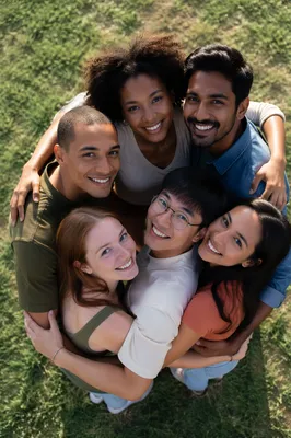 Six Friends Hug Circle on Grass