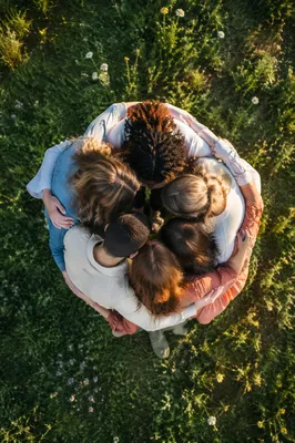 Overhead Friends Group Hug in Sunlit Meadow