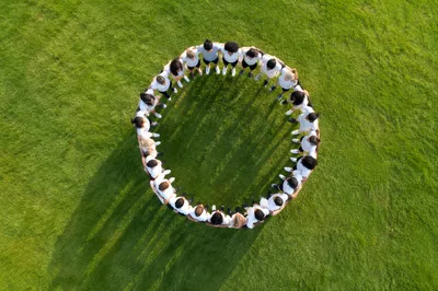Friends Group Hug Circle on Green Lawn