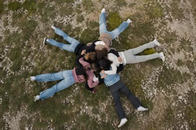 Overhead Friends Circle Hug on Grass