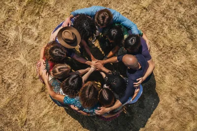 Overhead Friends Circle Hug in Golden Field