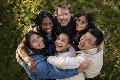 Six Friends Hugging in Park Circle