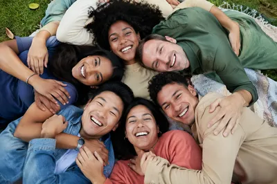 Six Friends Hugging on Picnic Blanket