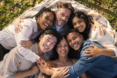 Six Friends Hugging on Picnic Blanket