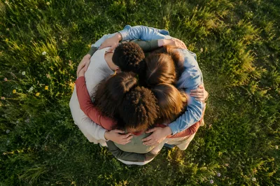 Overhead Friends Group Hug in Meadow