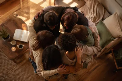 Overhead Friends Circle Hug in Warm Living Room