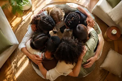 Overhead Friends Group Hug in Sunlit Living Room