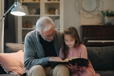 Grandfather and Grandchild Reading Bible Together