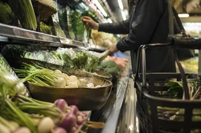 Candid Grocery Cart in Produce Aisle