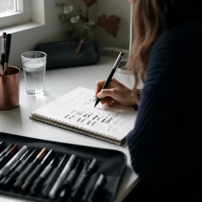 Hand Lettering Practice at a White Desk