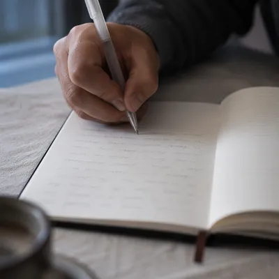 Hand Writing in a Quiet Prayer Journal