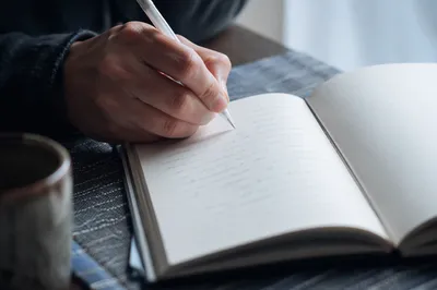 Hand Writing in a Quiet Prayer Journal
