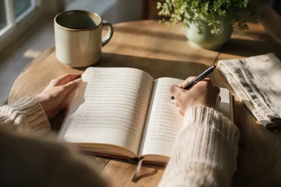 Hands Writing in Prayer Journal Morning Light