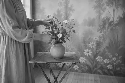Hands Arranging Wildflowers in Vintage Vase